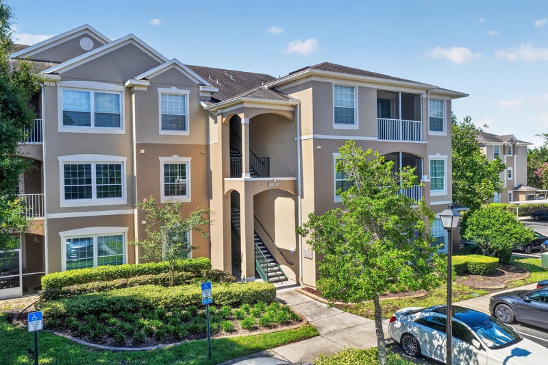 Condo building exterior with parking at 7990 Baymeadows Rd E #404, Jacksonville, FL 32256