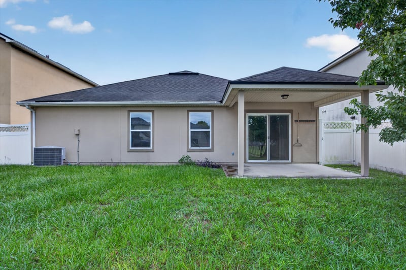 Back exterior with patio and fenced yard at 469 Glendale Ln, Orange Park, FL