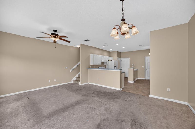 Living area with view toward kitchen and staircase at 1572 Biscayne Bay Dr, Jacksonville, FL 32218