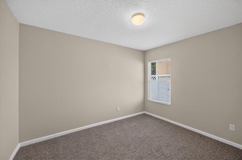 Carpeted bedroom with window at 469 Glendale Ln, Orange Park, FL