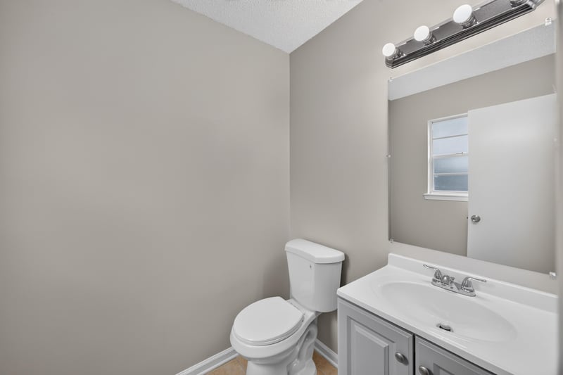 Bathroom with vanity mirror and toilet at 1040 Willow Cove Ct E, Jacksonville, FL 32233