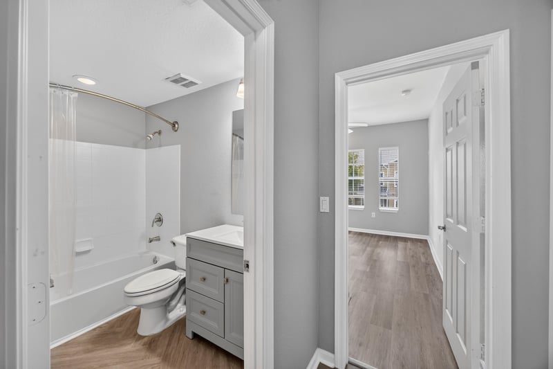Bathroom with tub-shower combo and hallway view at 10075 Gate Pkwy unit 1905, Jacksonville, FL 32246
