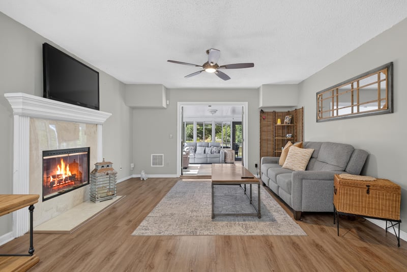 Living room with fireplace open to kitchen at 8680 Bandera Cir S, Jacksonville, FL 32244