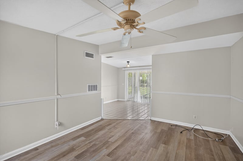 Living room with wood-look flooring and ceiling fan at 87 Saratoga Cir S, Atlantic Beach, FL