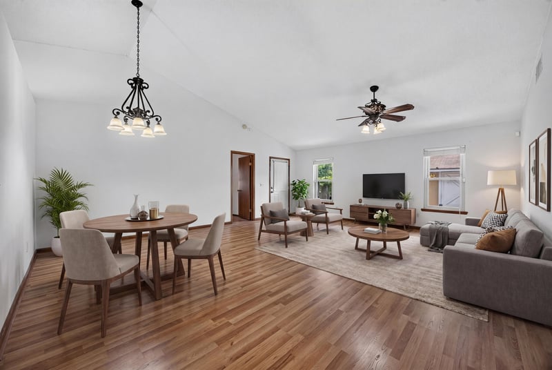 Open living and dining area with wood floors and vaulted ceiling at 2460 San Sago Ln, Jacksonville, FL