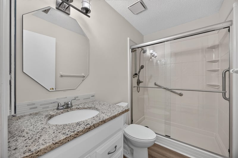 Bathroom with glass shower door and grab bars at 3407 Fairbanks Grant Rd N, Jacksonville, FL 32223