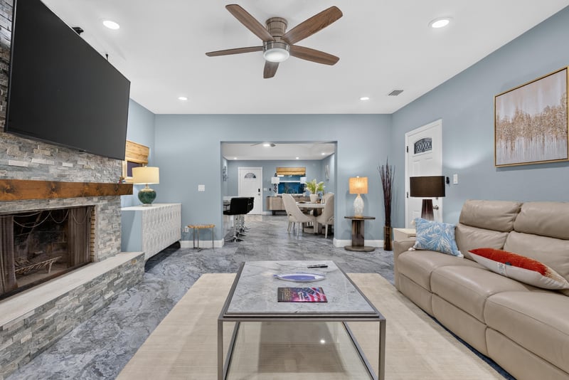 Living room with sectional seating and fireplace at 1525 8th St N, Jacksonville Beach, FL