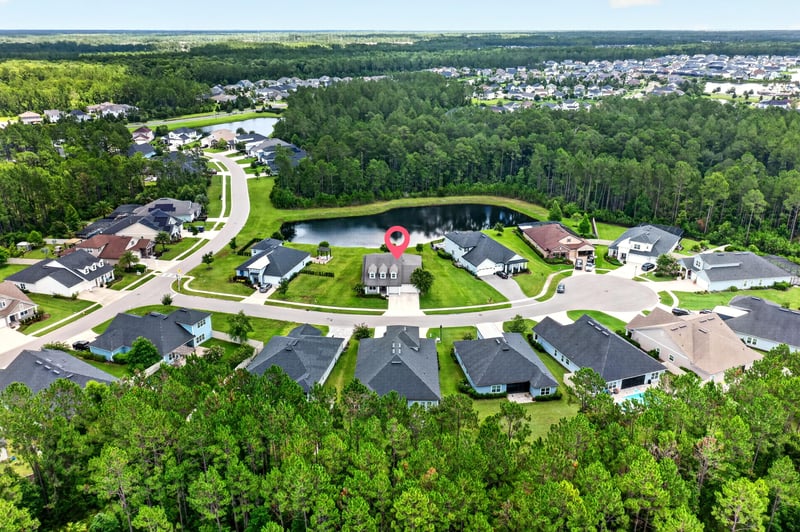 Aerial view with location pin marking the home among ponds and streets at 53 Lumen Ct, St. Augustine, FL 32095