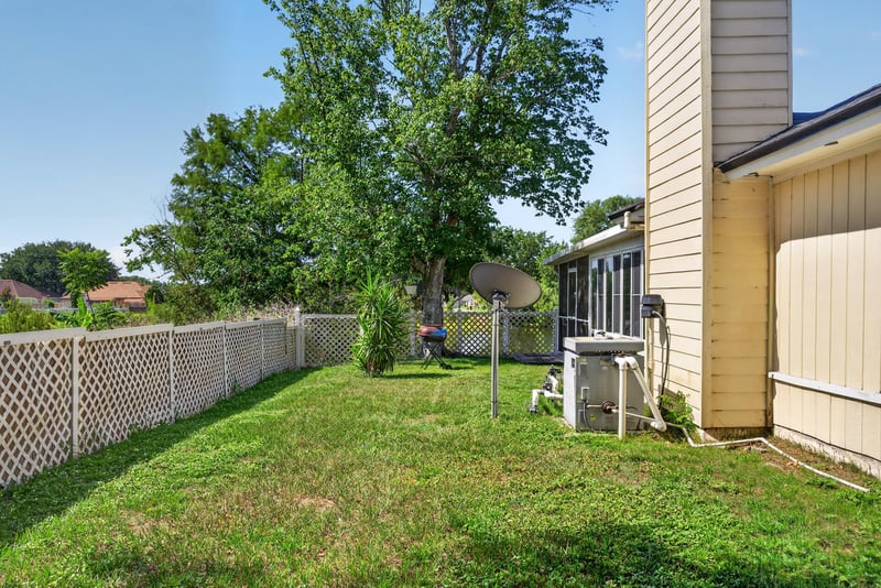 Fenced backyard with trees at 8680 Bandera Cir S, Jacksonville, FL 32244