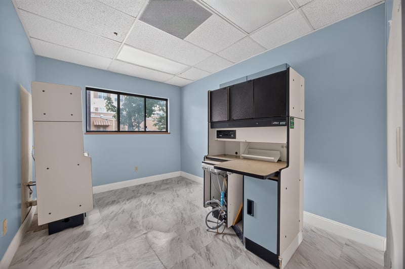 Room with wall-mounted TV and built-in cabinet at 1543 Kingsley Ave #19, Orange Park, FL 32073