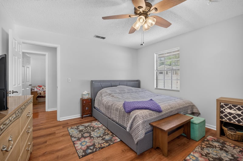 Bedroom with two beds and ceiling fan at 2435 Range Line Rd, Middleburg, FL