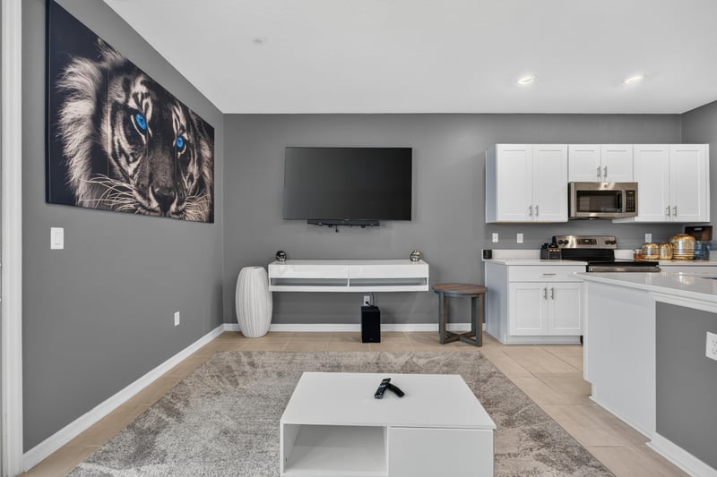 Living room with wall-mounted TV and area rug at 339 Anthony Dr, Jacksonville, FL
