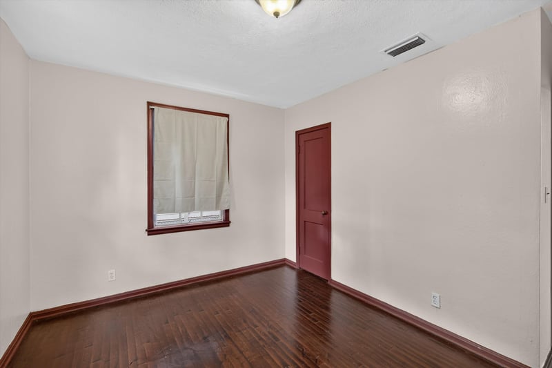 Empty room with window and red trim door at 2132 Allandale Cir W, Jacksonville, FL