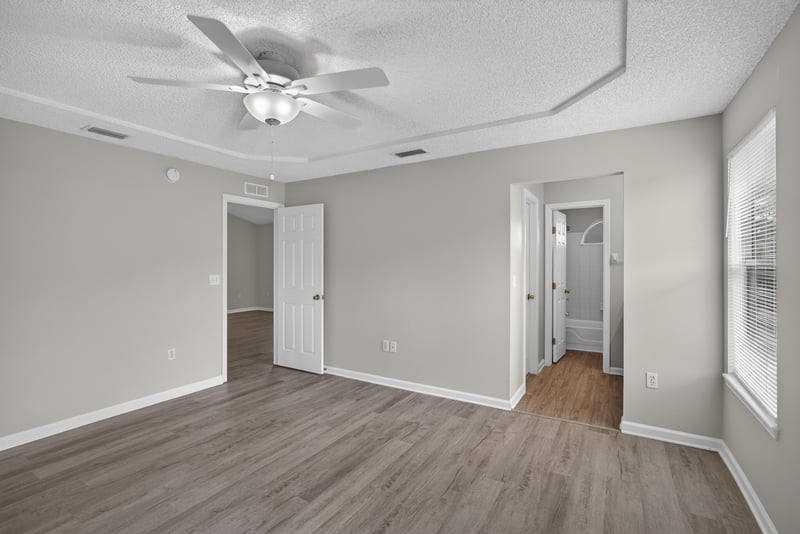 Bedroom with ceiling fan and multiple windows at 8519 Blazing Star Ct, Jacksonville, FL 32210