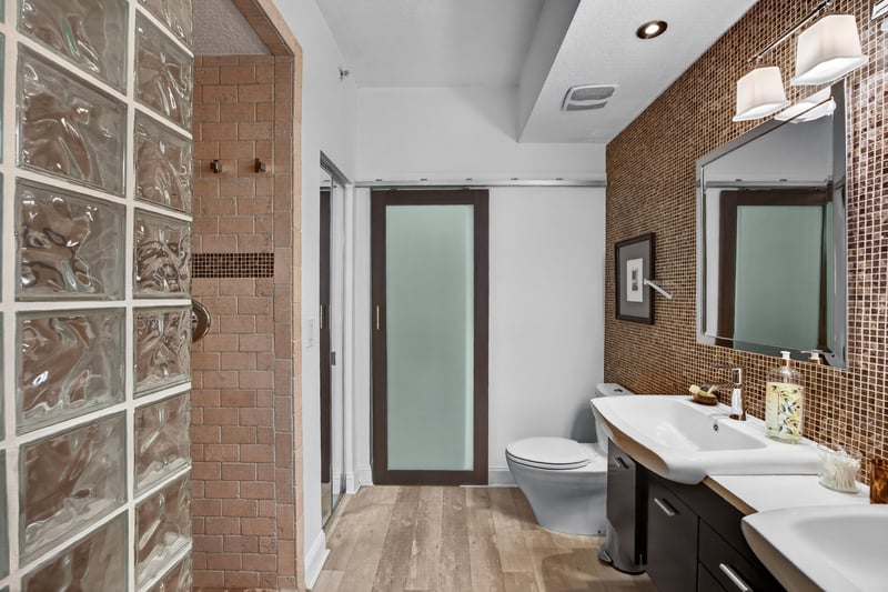 Primary bathroom glass-block shower and vanity at 10435 Mid Town Pkwy unit 135, Jacksonville, FL 32246