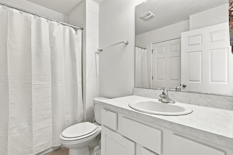 Bathroom with tub, shower curtain and vanity at 8359 Zenith Cir, Jacksonville, FL 32256