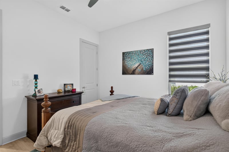 Bedroom with neutral bedding and windows at 785 Back Creek Dr, St. Augustine, FL 32092