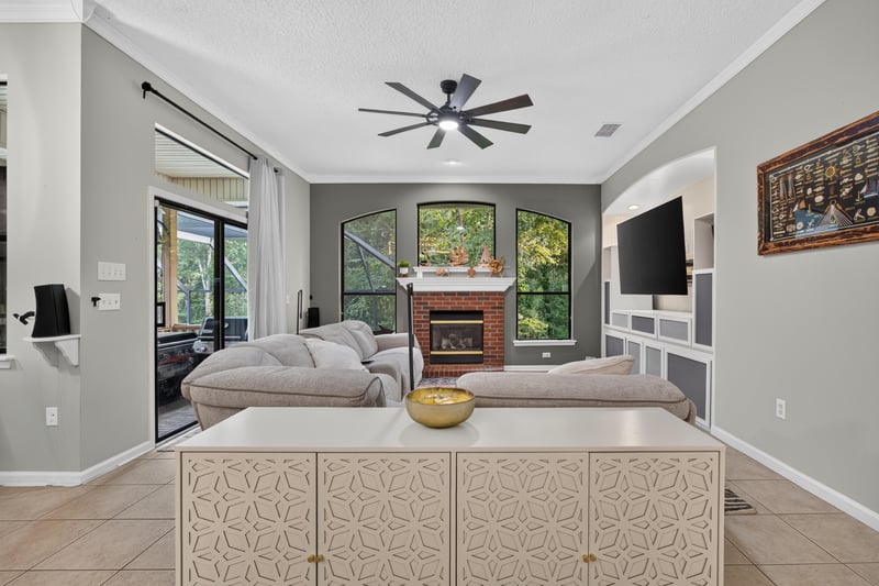 Living room fireplace with large windows at 2125 Blue Heron Cove Dr, Orange Park, FL 32003