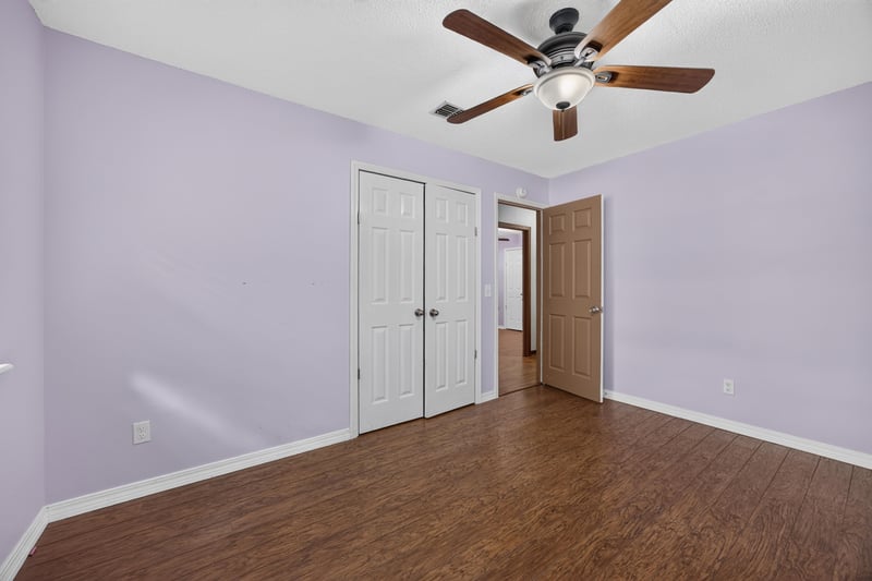 Bedroom with double closet and wood floors at 892 Branscomb Rd, Green Cove Springs, FL