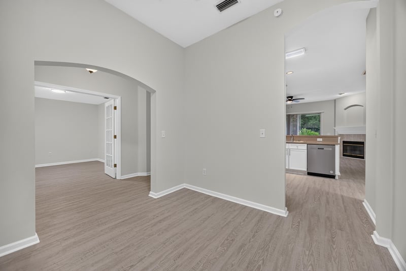 Open living area with archways leading to kitchen at 706 Bonaparte Dr, Jacksonville, FL 32218