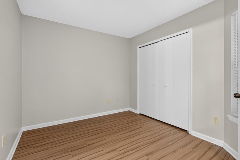Bedroom with closet doors at 8010 International Village Dr, Jacksonville, FL 32277