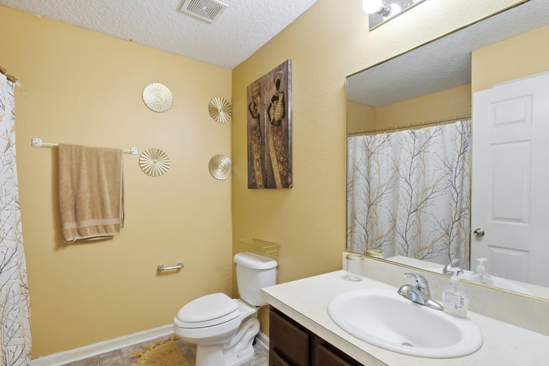 Bathroom with tub-shower combo and pedestal sink at 7392 Timber Falls Ct
