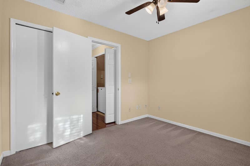 Empty room with carpet leading to hallway at 353 Redwood Ln