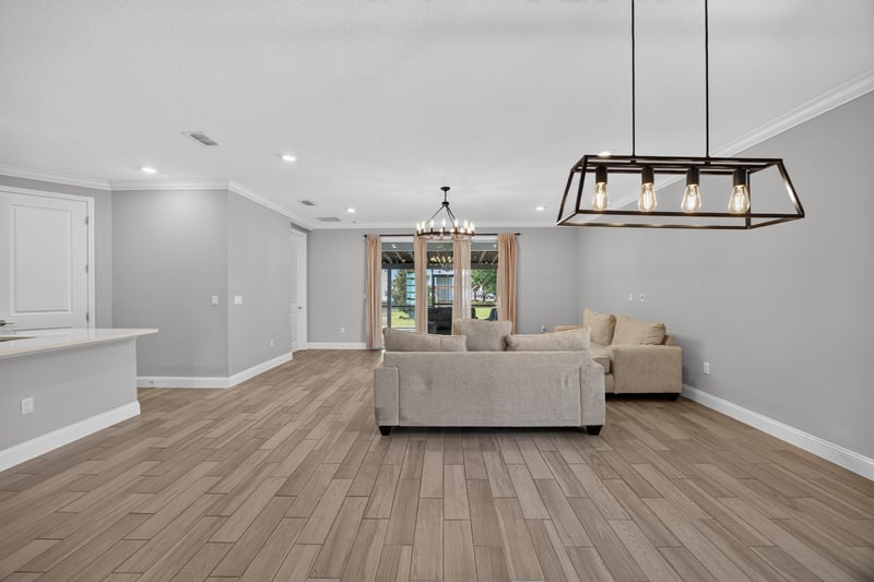 Living and dining area with a wagon-wheel chandelier at 91 Tilloo Ct, St. Johns, FL