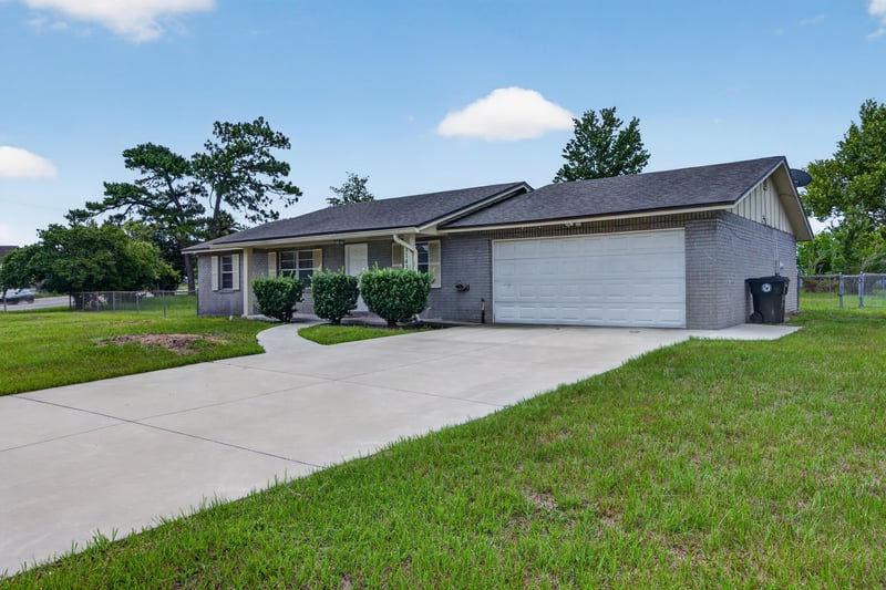 Front exterior with driveway and garage doors at 1143 Tumbleweed Dr, Orange Park, FL 32065