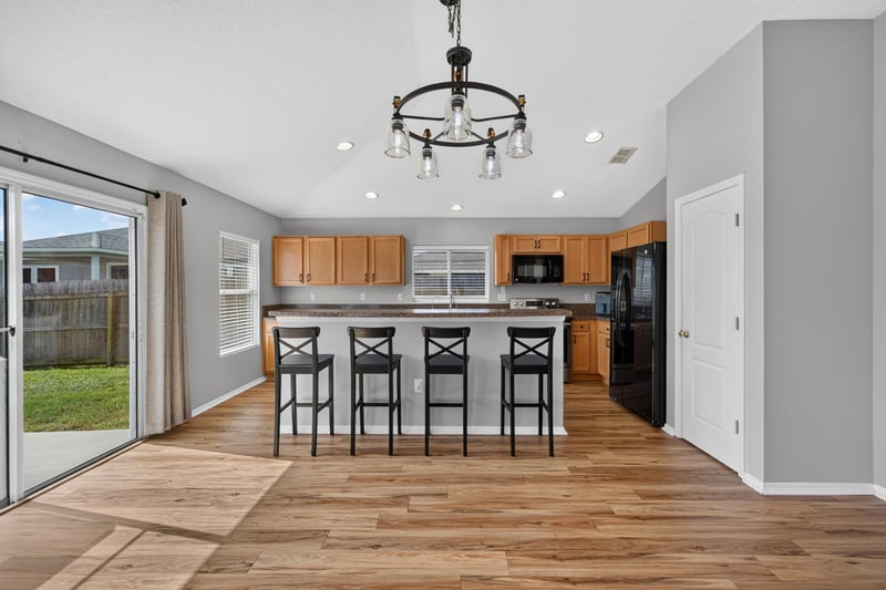 Kitchen island with pendant lighting at 7545 Lirope St, Jacksonville, FL 32244