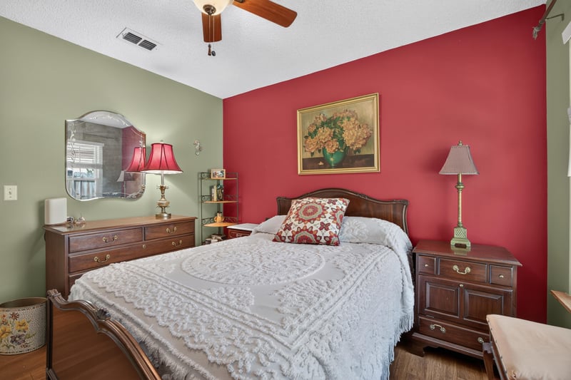 Bedroom with green walls and nightstand lamps at 4837 Pareja Ct, Jacksonville, FL 32225