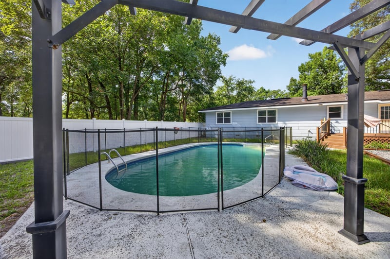 Pool with safety fence and pergola at 892 Branscomb Rd, Green Cove Springs, FL