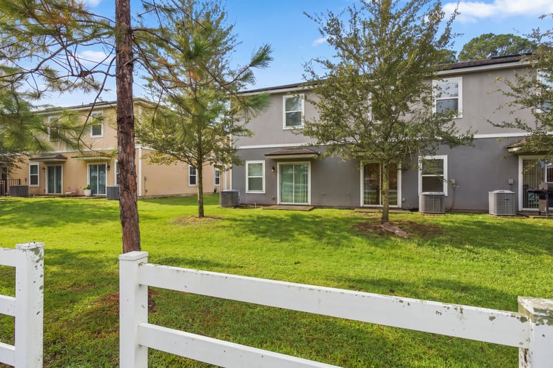 Grass area with white fence and trees in Jacksonville, FL