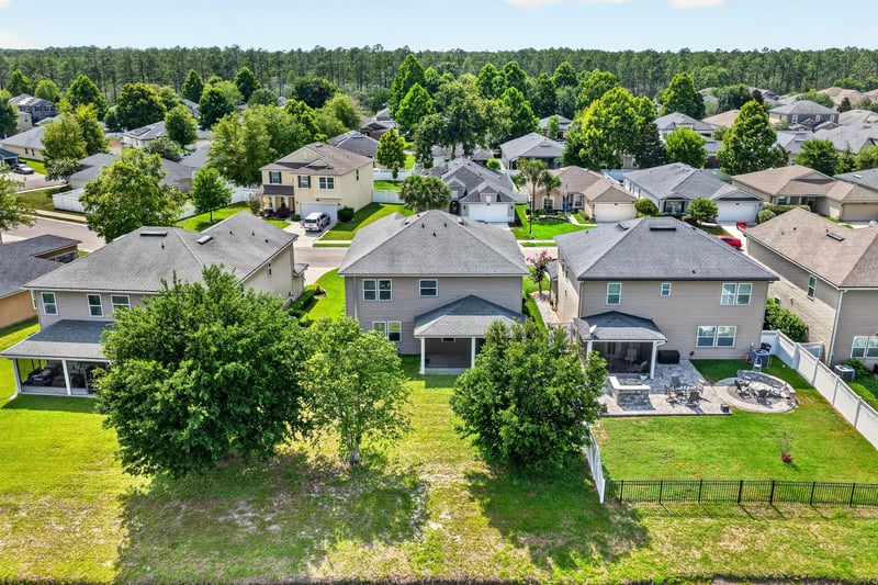 Drone view of home and surrounding neighborhood rooftops at 263 Gilmore Ln, Orange Park, FL 32065