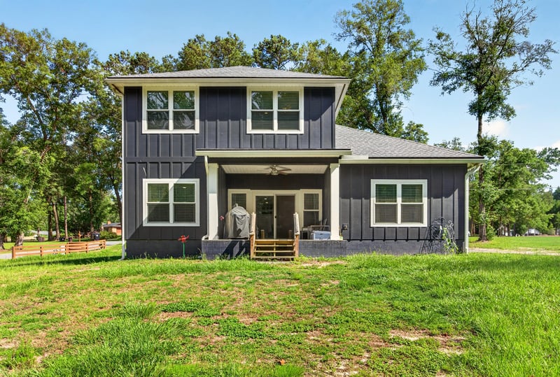Rear exterior view of the two-story home and yard at 2817 Camel Cir, Middleburg, FL