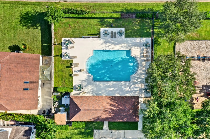 Aerial view of community pool surrounded by trees in Johns Creek