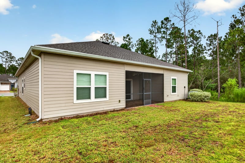 Rear exterior with screened porch at 9905 Ansley Lake Dr, Jacksonville, FL
