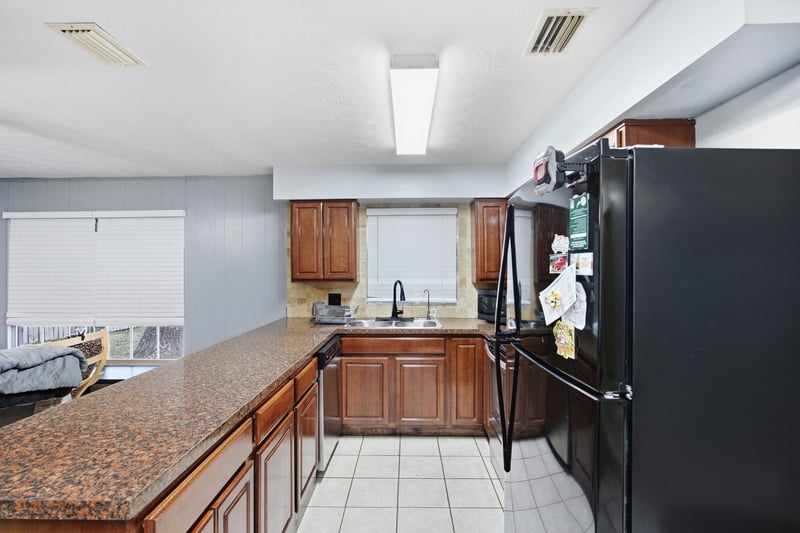 Kitchen with granite counters and black appliances at 417 Capricorn Ln, Orange Park, FL 32073