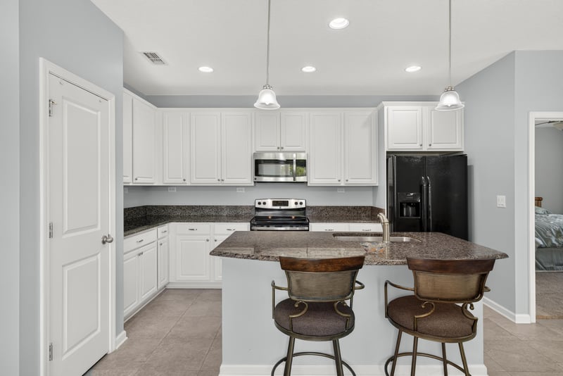 Kitchen island with bar stools at 2378 Caney Oaks Dr, Jacksonville, FL