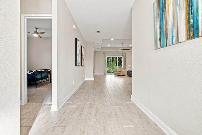 Hallway leading to secondary bedrooms with wood-look flooring at 27 Holly Rdg Wy, St. Augustine, FL
