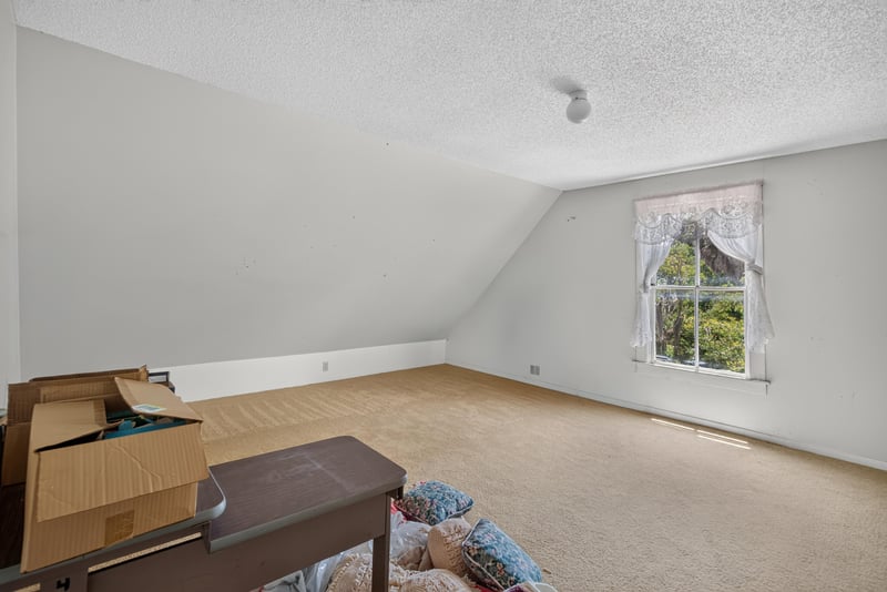 Attic room with window and open box at 1173 US-17, Satsuma, FL 32189