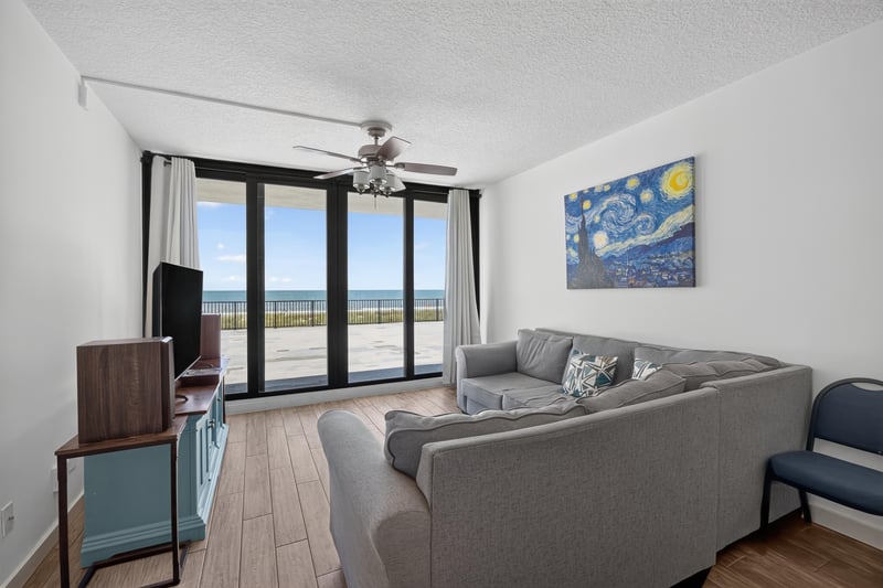 Living room sofa facing sliding glass doors at 601 1st St S, Jacksonville Beach