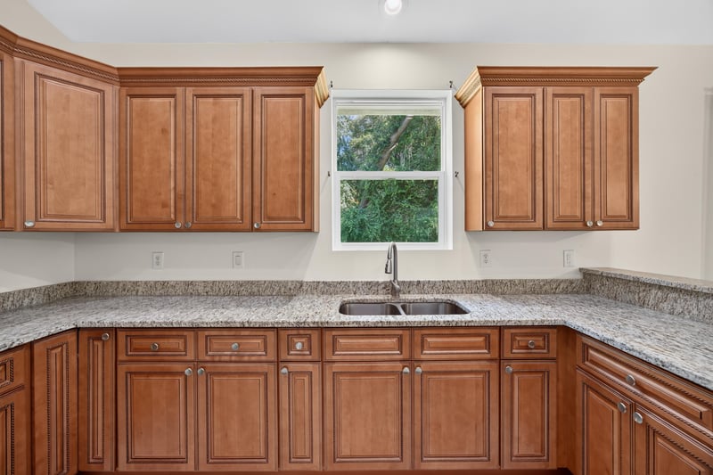 Kitchen sink area with granite counters and window at 1012 Fruit Cove Rd, Jacksonville, FL 32259