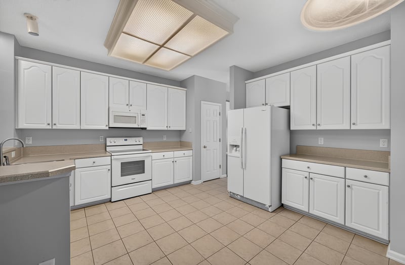 Kitchen with white cabinets and appliances at 470 Sparrow Branch Cir, Jacksonville, FL 32259