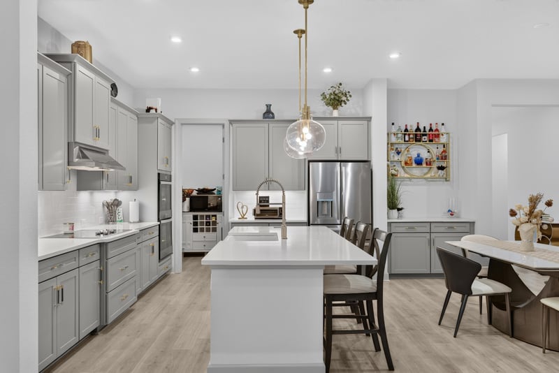 Kitchen island with dining table in background at 785 Back Creek Dr, St. Augustine, FL 32092