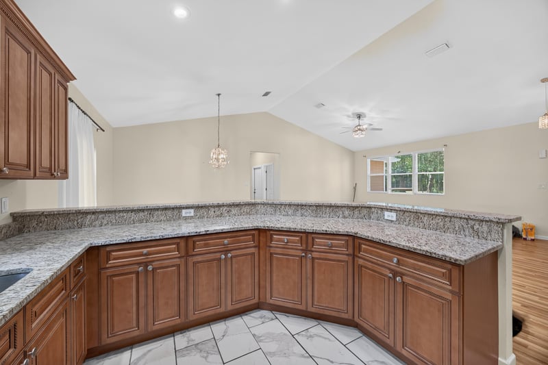 Kitchen counter and cabinets opening to living room at 1012 Fruit Cove Rd, Jacksonville, FL 32259