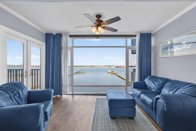 Living room with sliding glass doors to water-view balcony at 2280 Shepard St