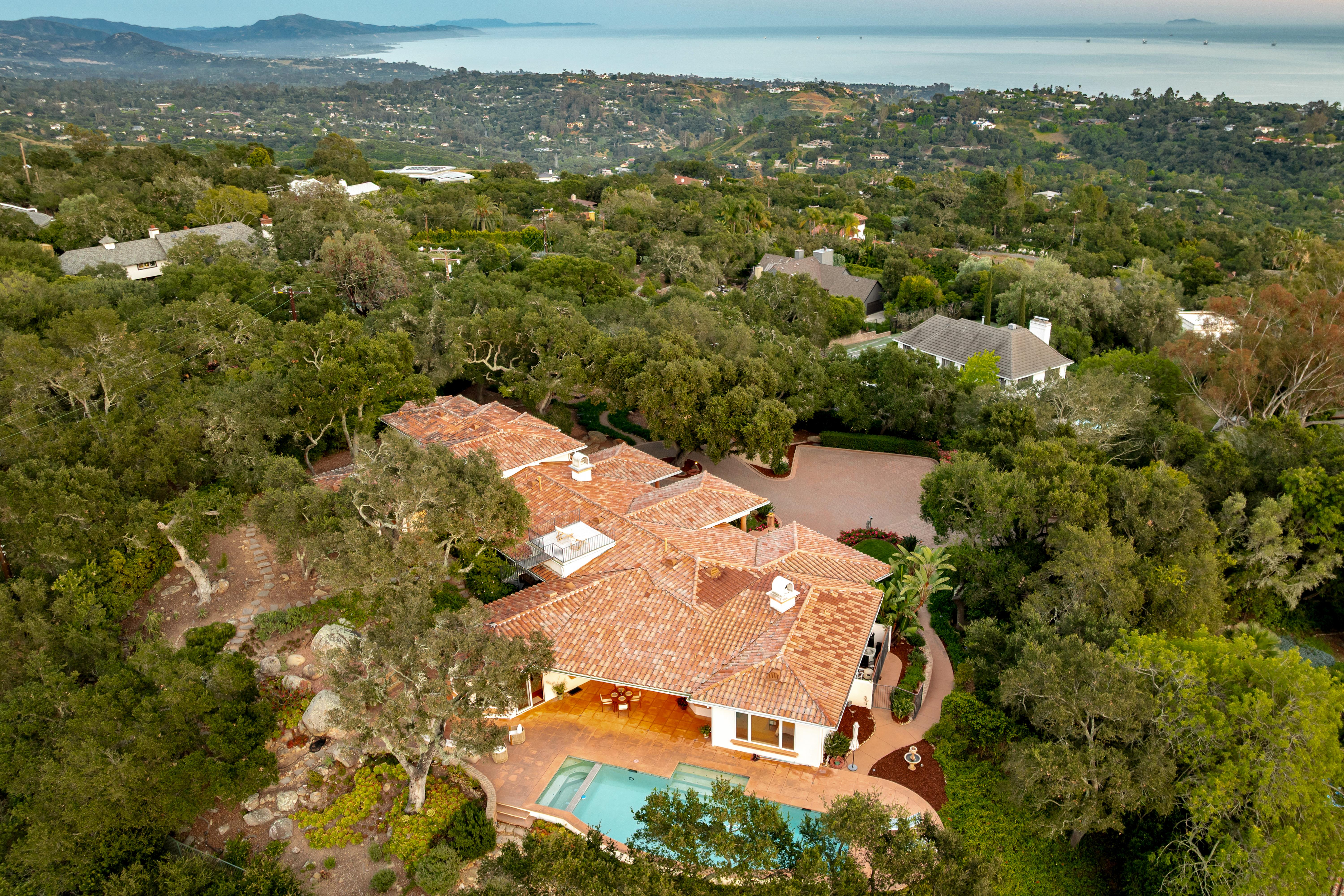 Exterior facade of luxury estate at 450 El Cielito Rd, Santa Barbara — professional real estate photography showcasing Santa Ynez Mountain views and architectural detail along the Santa Barbara Riviera. Our team captured still photography, aerial drone photography, twilight photography, a Matterport virtual tour, a 2D floor plan, and a custom property website from afternoon through twilight.