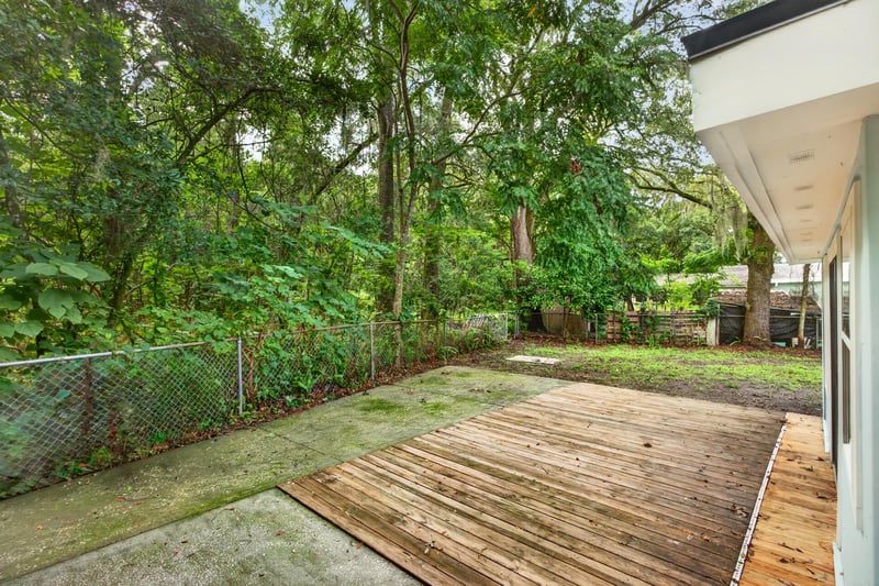 Backyard with grass and fenced tree line at 3113 Kline Rd, Jacksonville, FL 32246