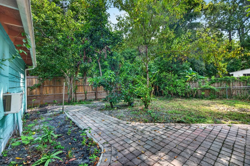 Backyard with trees and brick paver path at 2841 Ernest St, Jacksonville, FL 32205